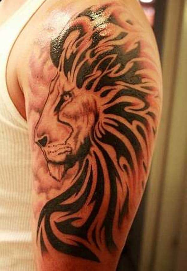 Arresting bold lion face with tribal decorations tattoo designs for Boys on shoulder