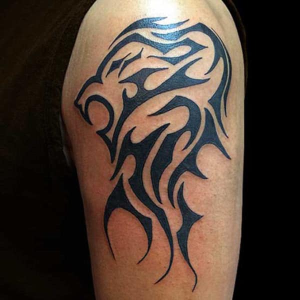 Exquisite tribal lion head dark lined tattoo ideas on arm for well-built Guys