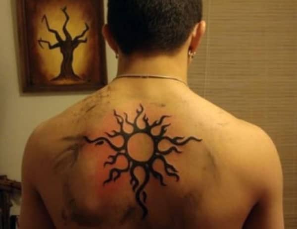 Root like tribal sun tattoo designs on back for Boys