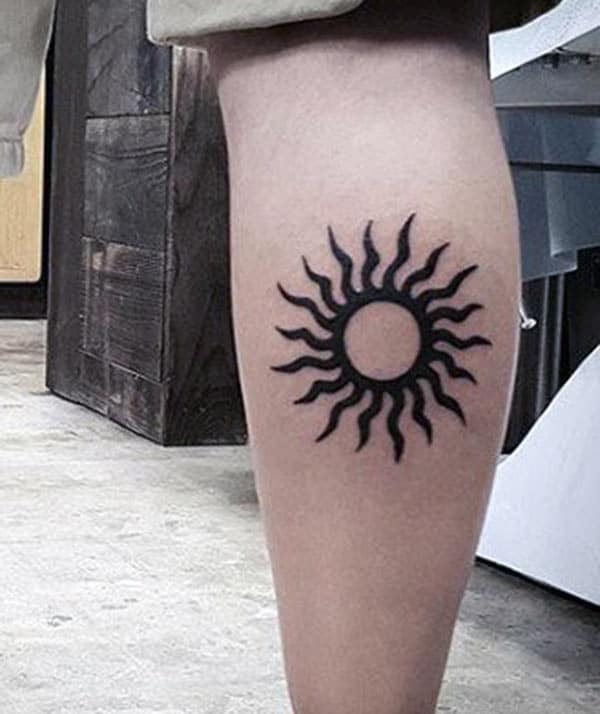 Symmetrical beautiful tribal sun tattoo ideas on leg for Men