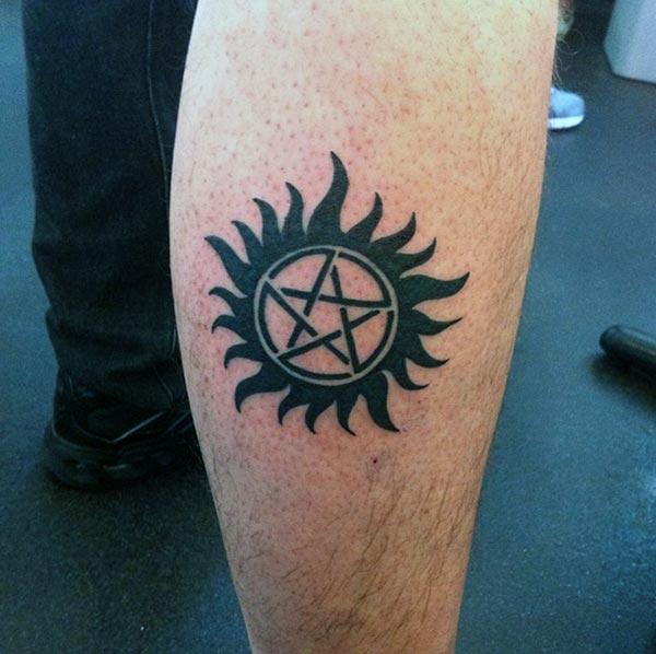 Aw-inspiring sun with star tribal tattoo ideas on calf for boys and men