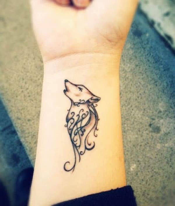 Beautiful tribal wolf howling tattoo design on forearm for Women