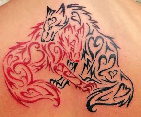 Stunning black and red tribal wolves tattoo design on the back shoulder of Women