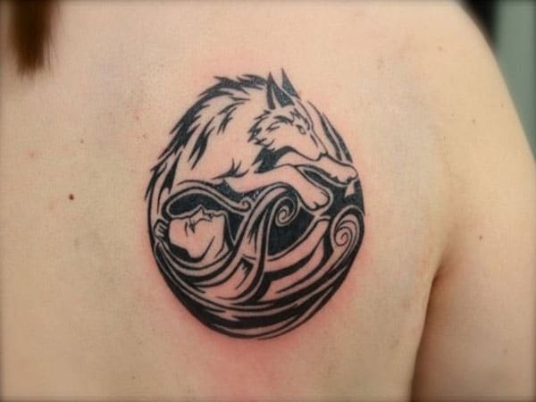 Striking wolf and man circle tribal tattoo design on back shoulder for girls and women