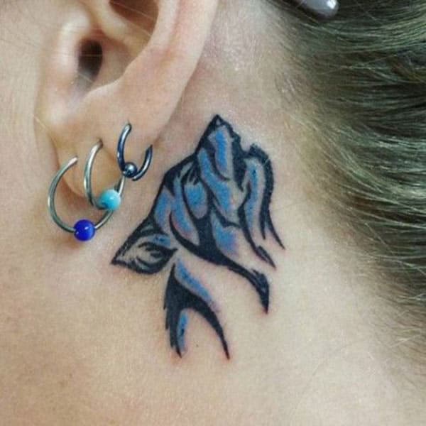 Captivating cool blue howling wolf tribal tattoo ideas on ear back for Stylish girls