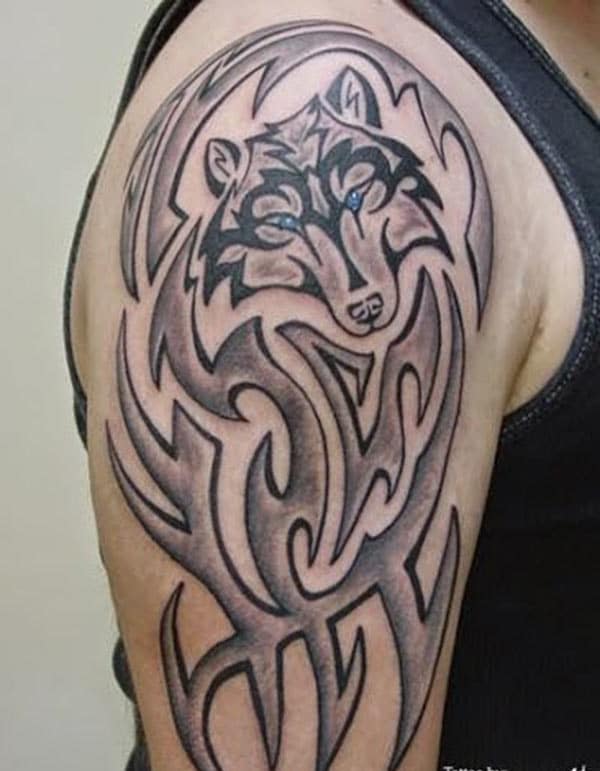 Brilliant Celtic tribal wolf head with blue eye tattoo ideas for men on shoulder
