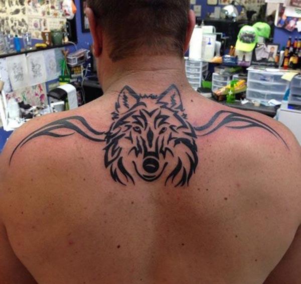 Men’s Jaw-dropping tribal wolf head with wings tattoo ideas on back for Masculine look