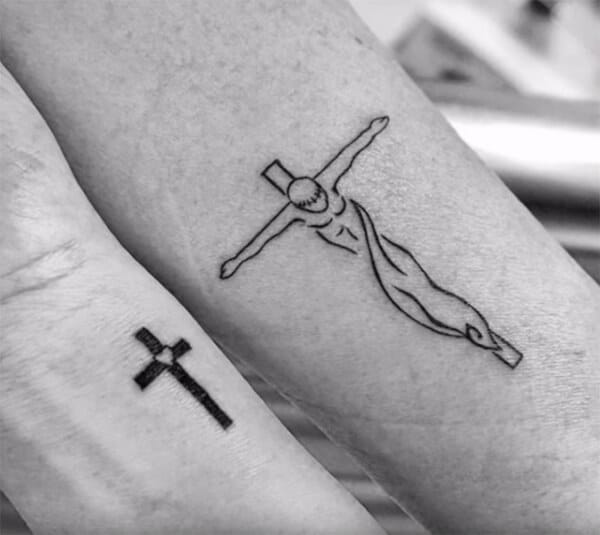 A unique style cross tattoo for men on forearm