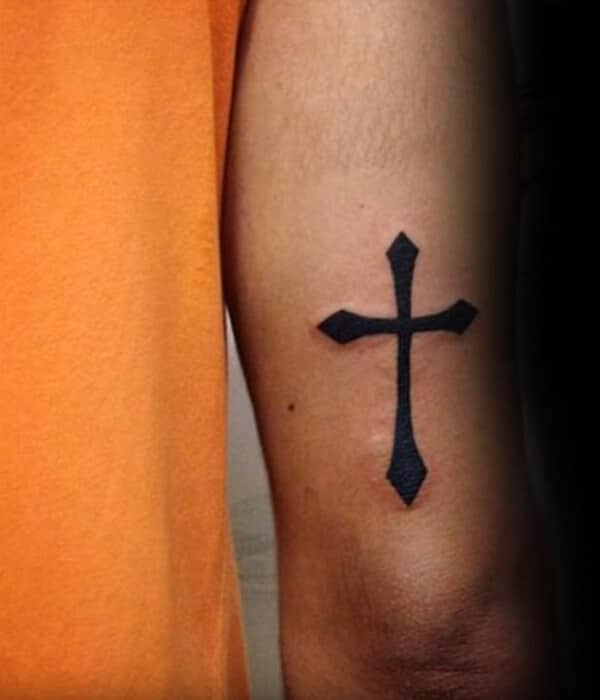 Intense black catchy cross tattoo design on arm for Guys
