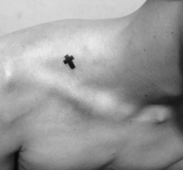 Tiny broad black cross tattoo ideas on shoulder-neck for Guys