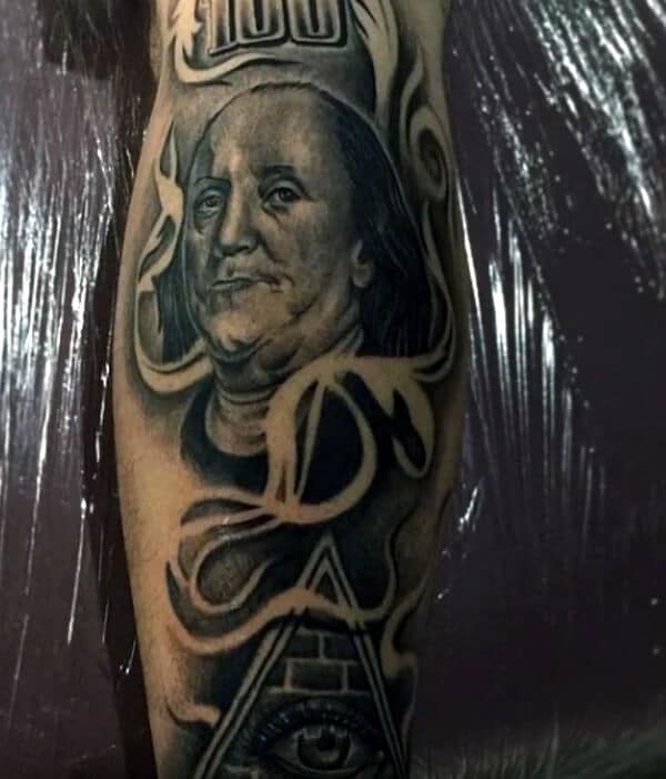 A stunning tattoo design on arm of 100 dollar above eye of triangle for Men