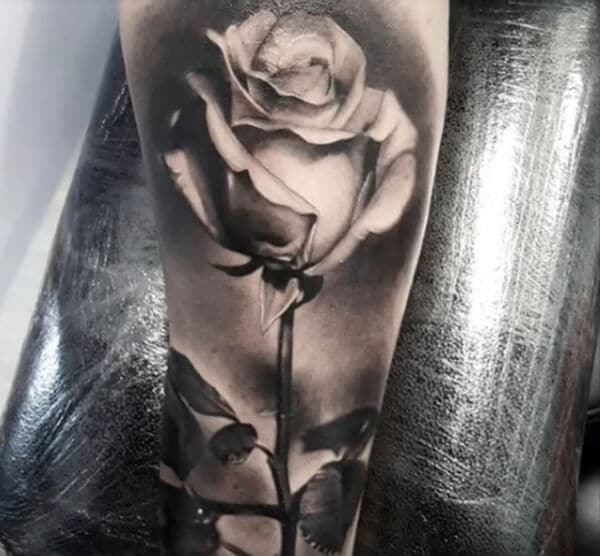Striking black and white rose tattoo ideas on arm for Guys