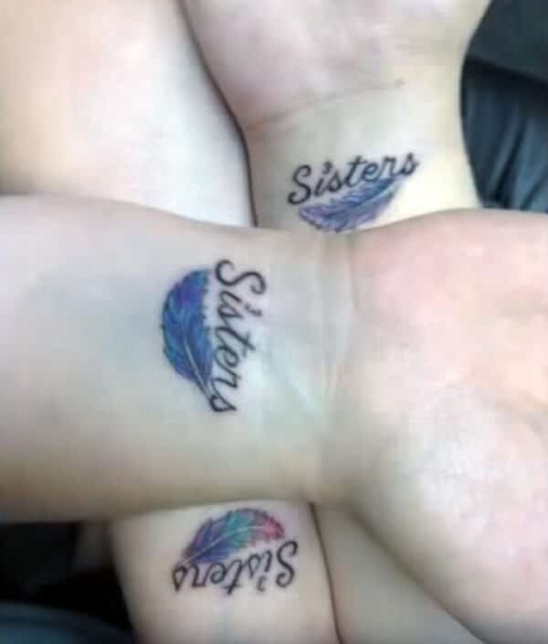Sisters word with feather tattoo ideas on wrist for girls and women