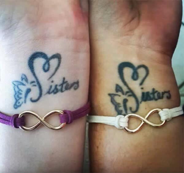 Creative awesome sisters word tattoo design on wrist for Girls