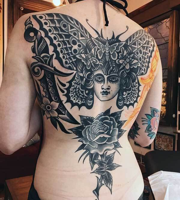 thrilling black and white tattoo on back for girls