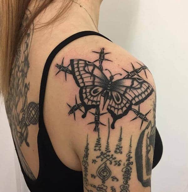 attractive butterfly on barbed thorns tattoo design on shoulder 