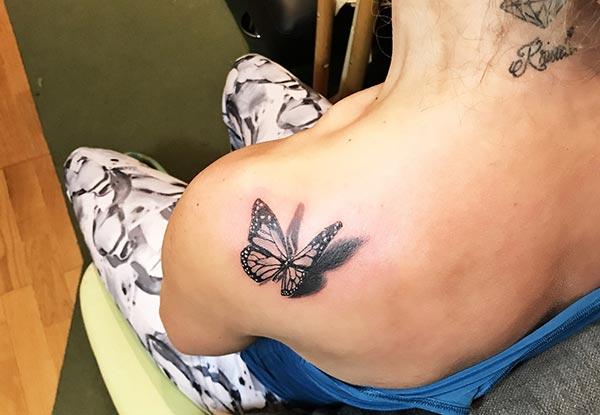 An arresting butterfly tattoo design on shoulder for ladies and girls