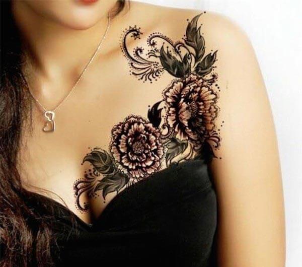 An intricate floral vine tattoo on side chest for girls