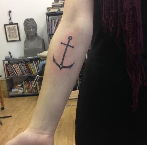 A simple dark anchor tattoo ideas on forearm for girls and women