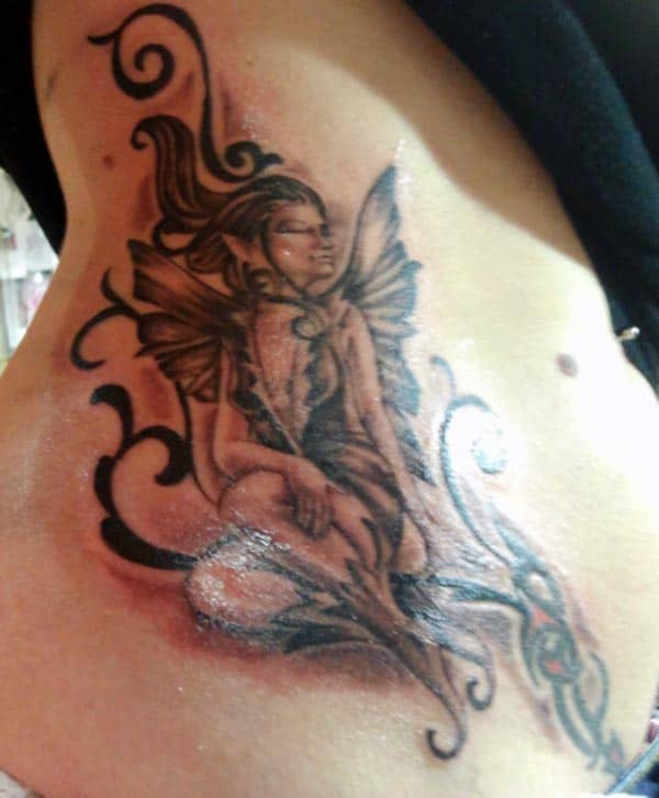 wonderful sitting angel tattoo designs on side belly for girls 