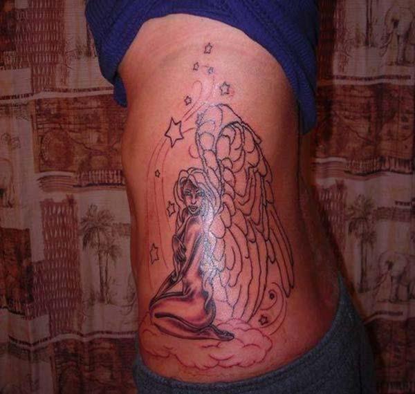 magical angel with large wing tattoo ideas on side belly 