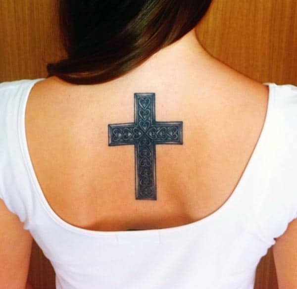 A mesmerizing cross tattoo design on back for girls