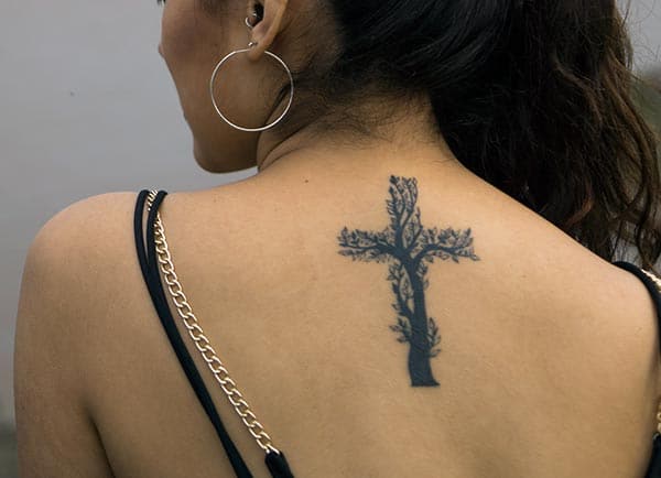 An awesome creative cross tattoo design on back shoulder for girls and ladies