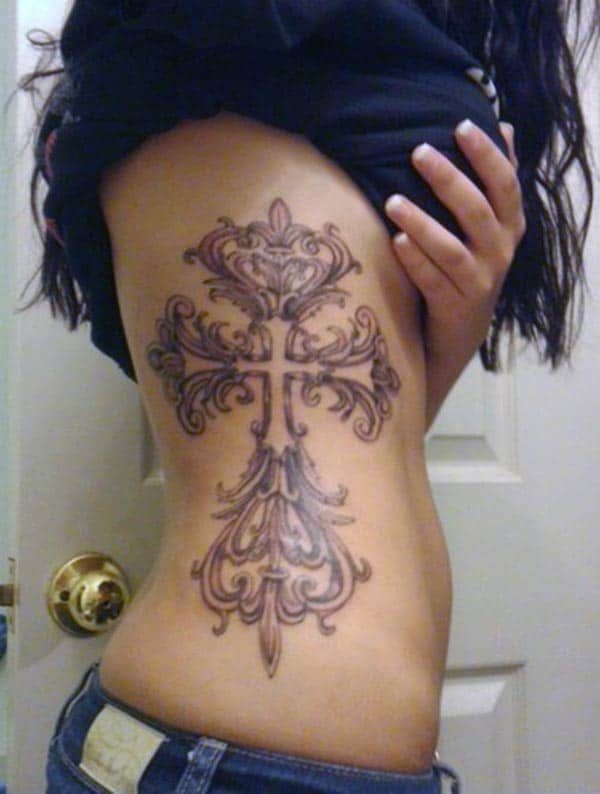 A magnificent cross tattoo design on side belly for Girls and women