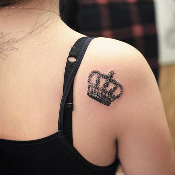 A bejeweled tiny crown tattoo design on shoulder back for girls