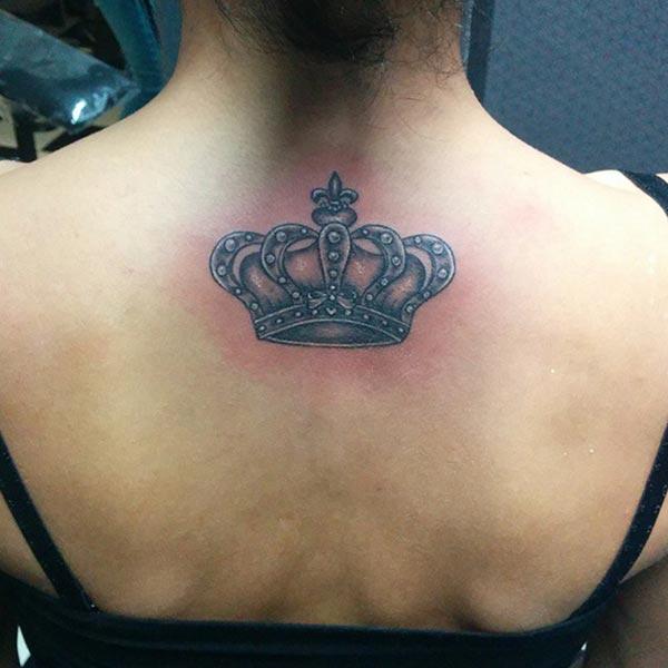 A realistic crown tattoo design on back for girls and women
