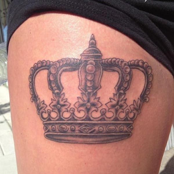 An aesthetic crown tattoo design on thigh for Ladies
