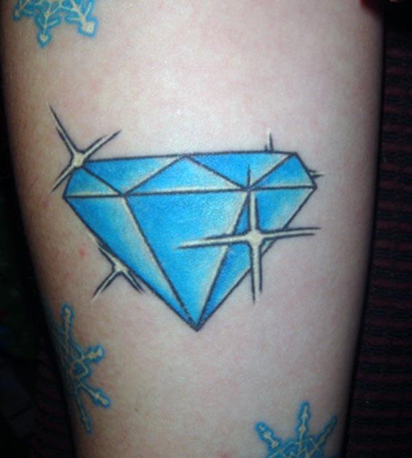 A sparkling blue diamond tattoo on arm for Ladies