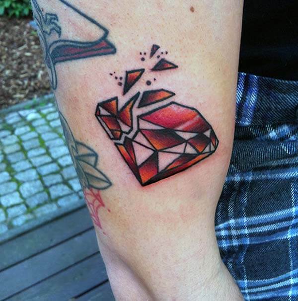 A broken red diamond tattoo design on arm for Girls