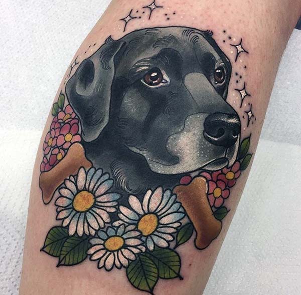 Engaging dog tattoo design on calf for Ladies
