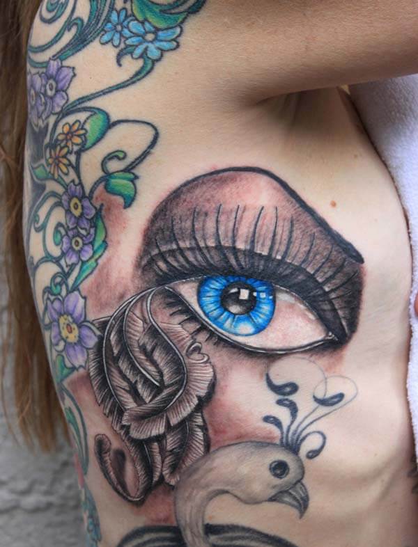 An enchanting eye tattoo design on side rib for Ladies