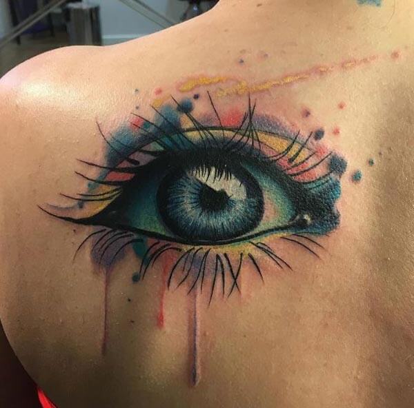 A vibrant charming eye tattoo design in back shoulder for Ladies