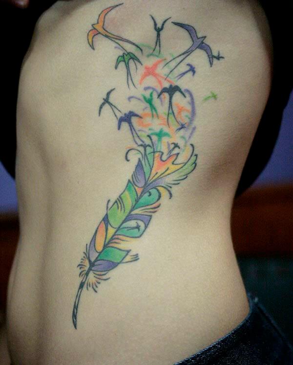 A vivid feather tattoo design on side rib for Girls and women