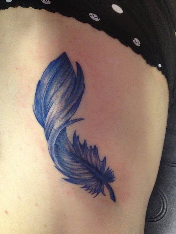 A lovely feather tattoo on side rib for girls and ladies