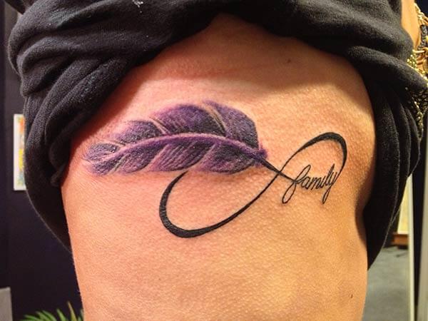 A beautiful feather tattoo design on side rib for Women