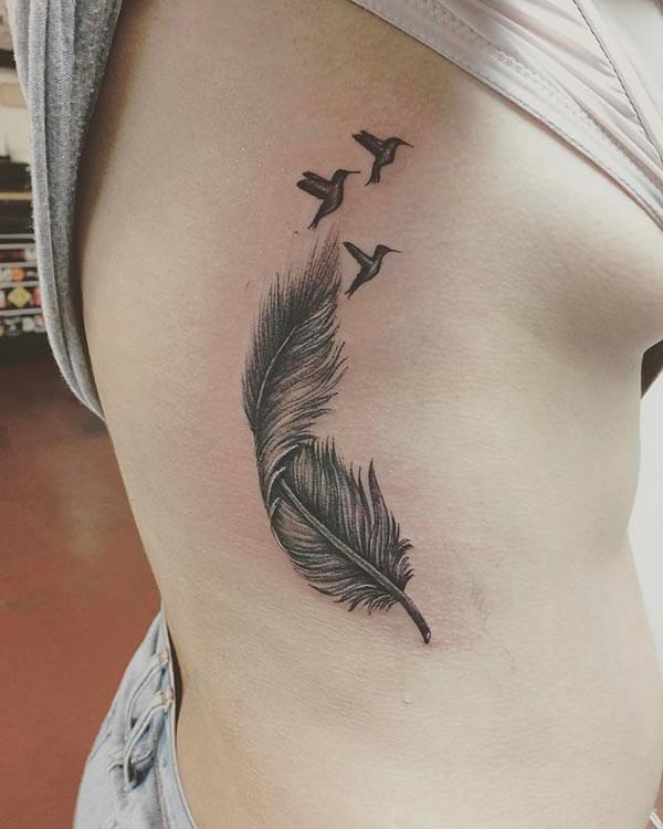 A mesmerizing feather tattoo design on side rib for Girls and women