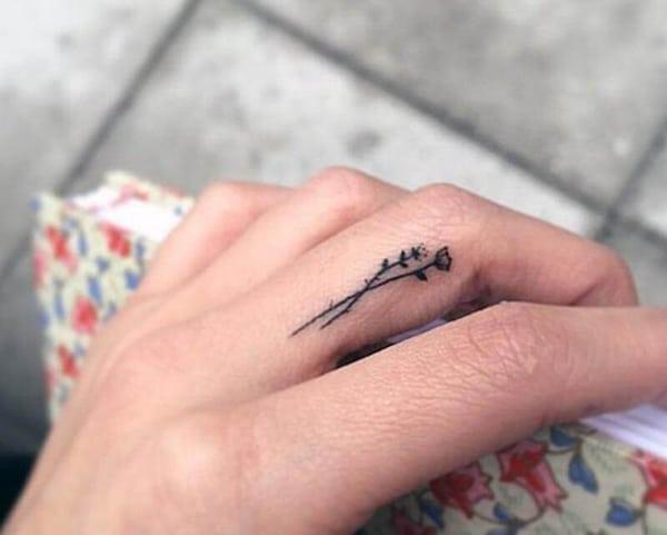 A lovely finger tattoo design on middle finger side for Girls
