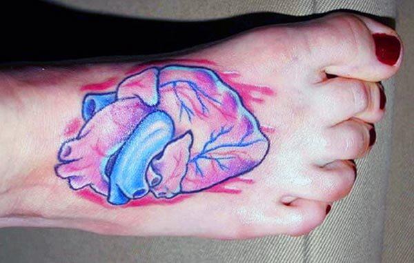 A realistic heart tattoo design on foot for ladies