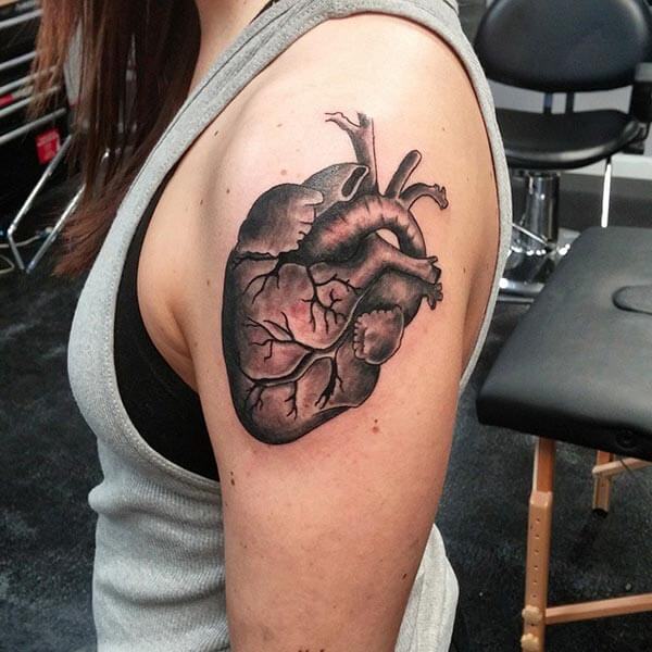 An artistic heart tattoo design on shoulder for women