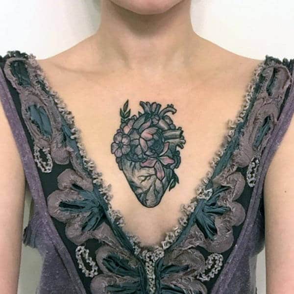 An impressive heart tattoo design on center of chest for Girls and women