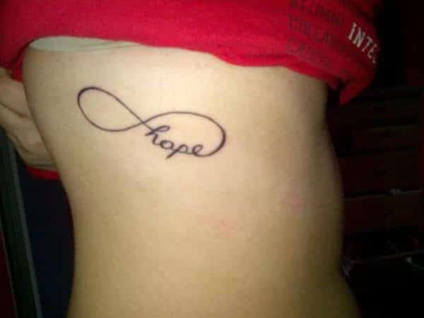 A lovely infinity tattoo design on side rib for ladies