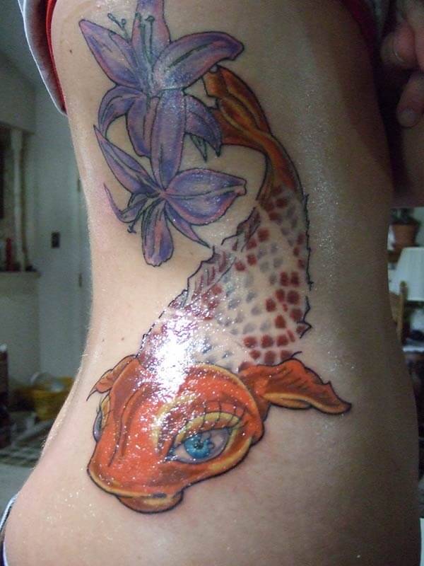 A brilliant Koi fish tattoo design on side belly for women
