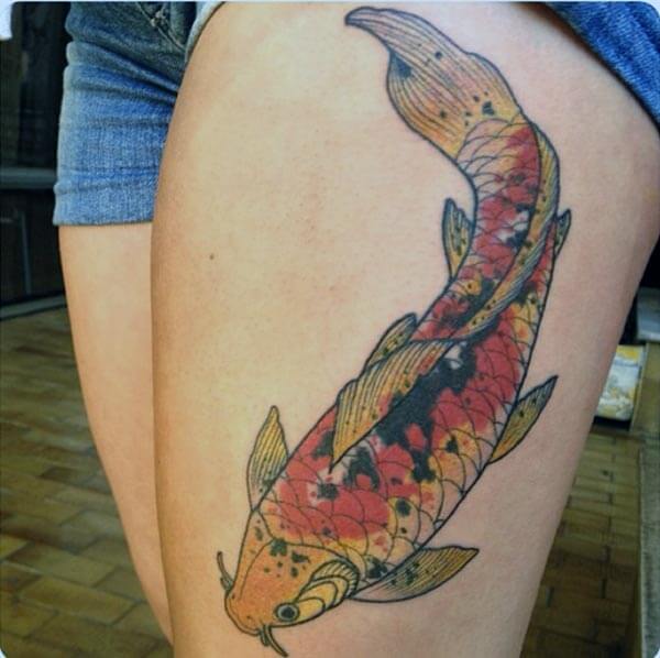 A mystique Koi Fish tattoo on thigh for Girls