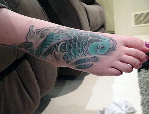 An amazing Koi Fish tattoo design on foot for ladies