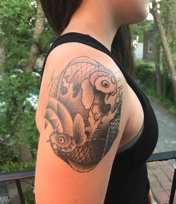 A lovely Koi fish tattoo design on shoulder for Girls