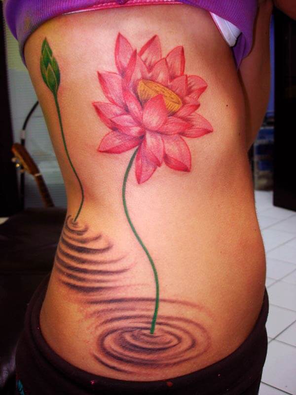 An aesthetic lotus flower tattoo design on side belly for women
